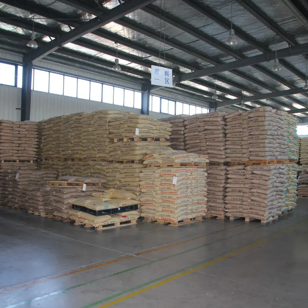 Rows of palletized 25 kg bags of CHIMEI ABS resin stored in a covered warehouse